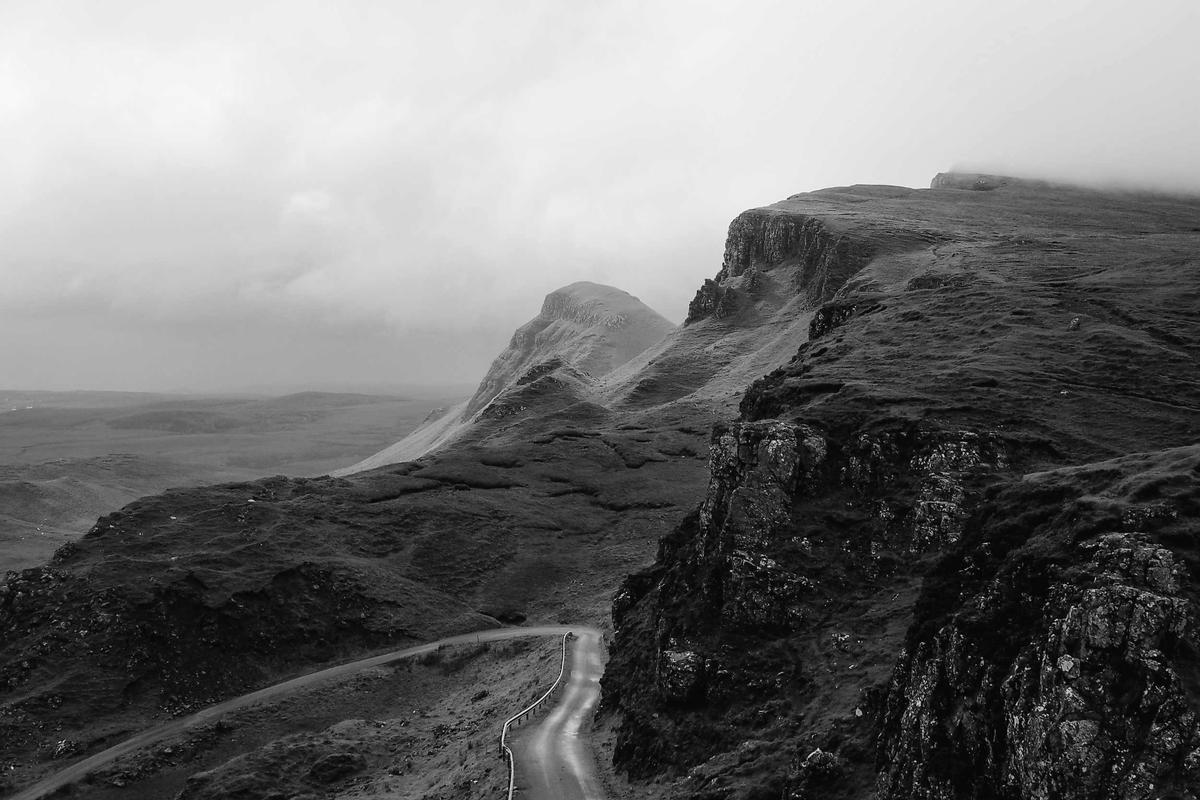 A road winding through vast highland terrain